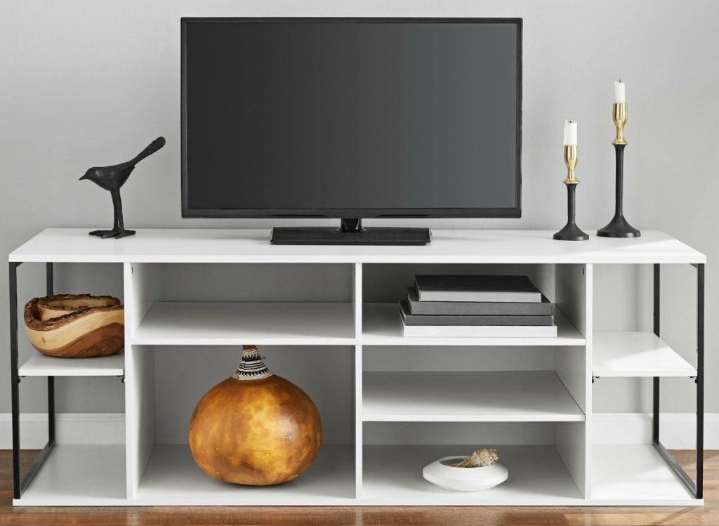 White wooden shelf with TV and decor