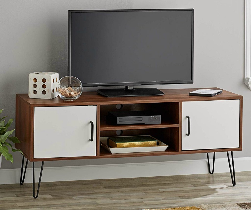 Brown TV stand with white doors and steel legs
