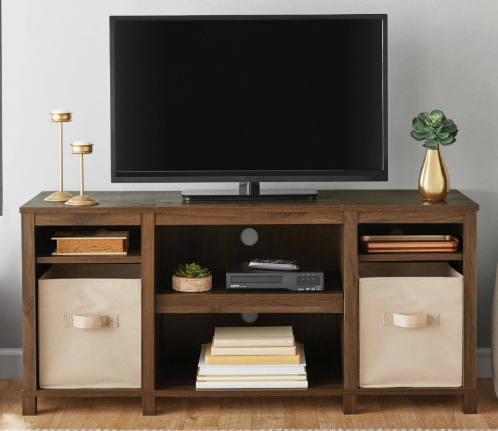 Cherry brown colored TV stand with beige drawers in living room set-up