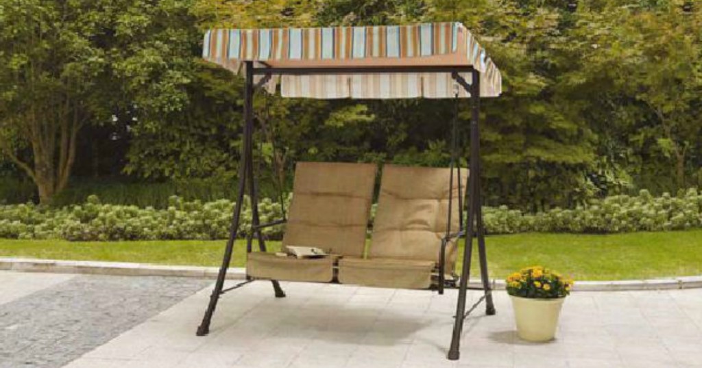 swing with striped canopy on patio
