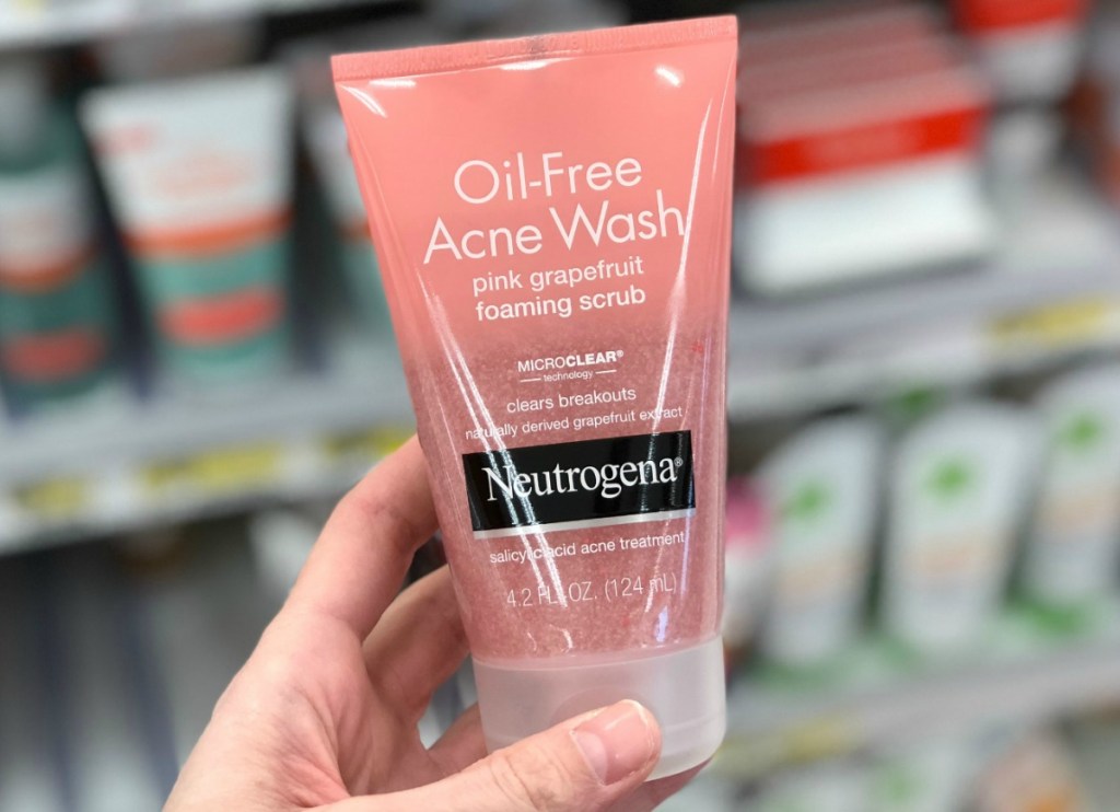 Pink grapefruit scented face wash by Neutrogena in hand in store