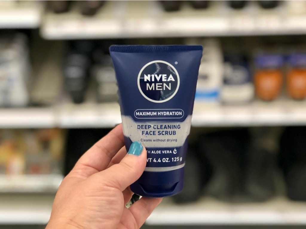 hand holding Nivea Men Face Scrub in Target aisle