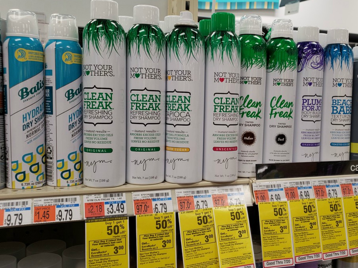 row of dry shampoo cans on a CVS store shelf