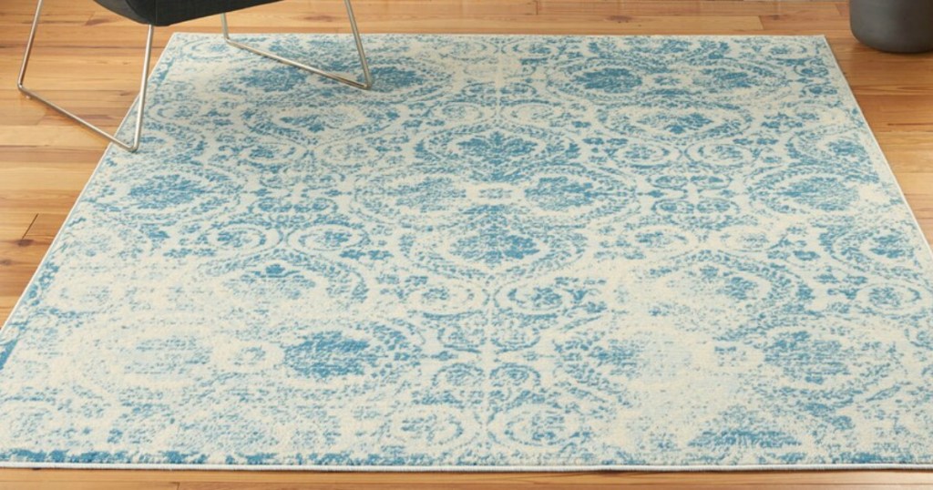 blue and white patterned rug on wood flooring