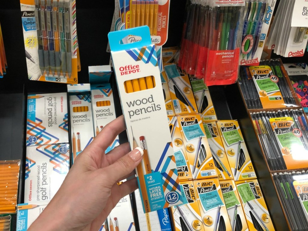 Hand holding up 12 pack of Office Depot Pencils