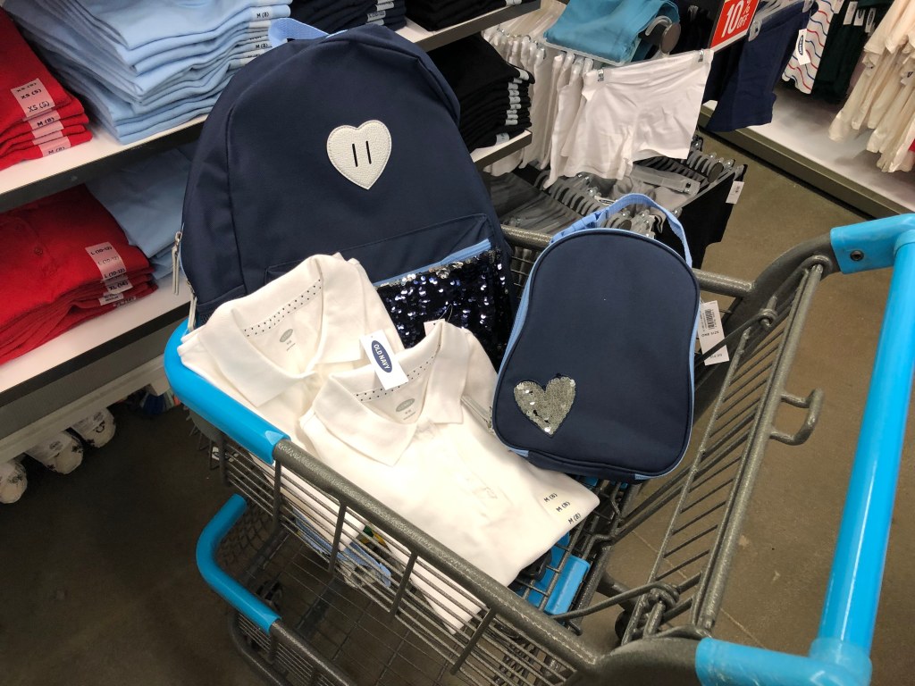 Old Navy Shopping Cart with clothing and a backpack in it