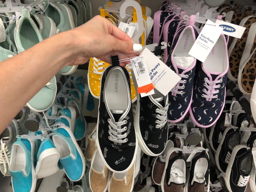 hand holding girls sneakers
