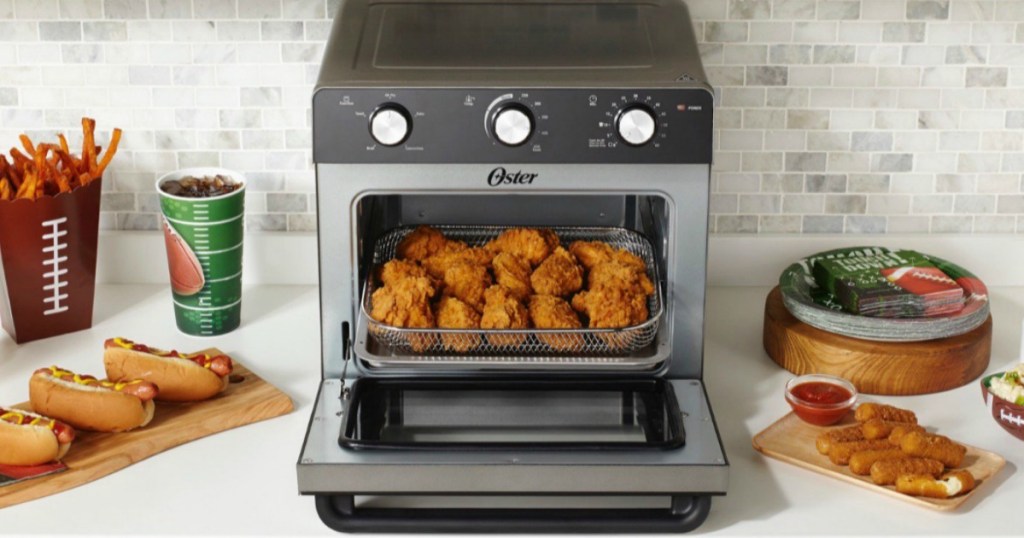 Oster Air Fryer Toaster Oven on counter with football appetizers all around it