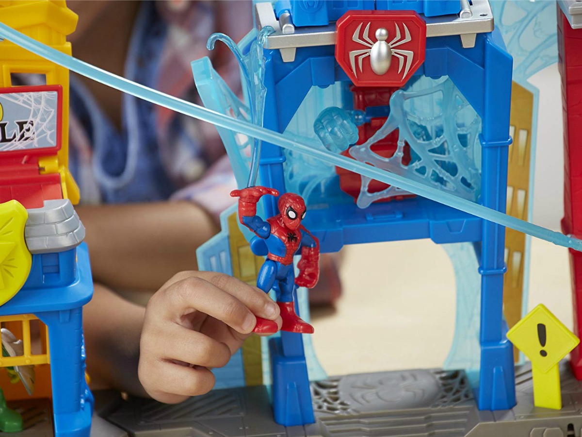 Kid holding spiderman in web-quarters playset