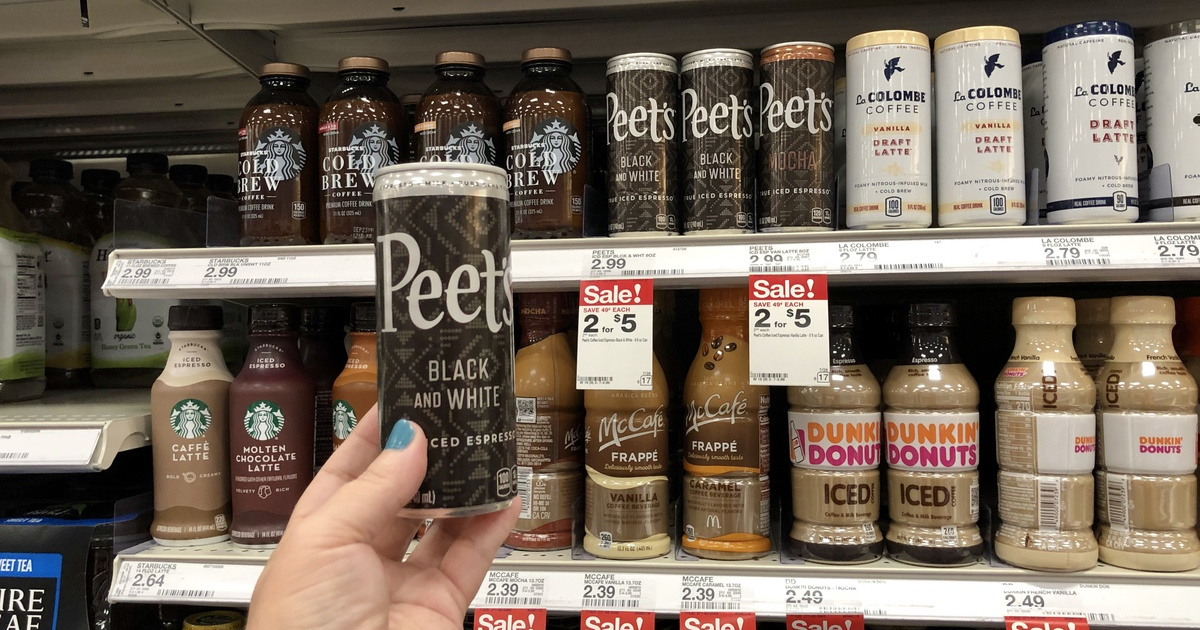 woman holding can of peets iced espresso at target