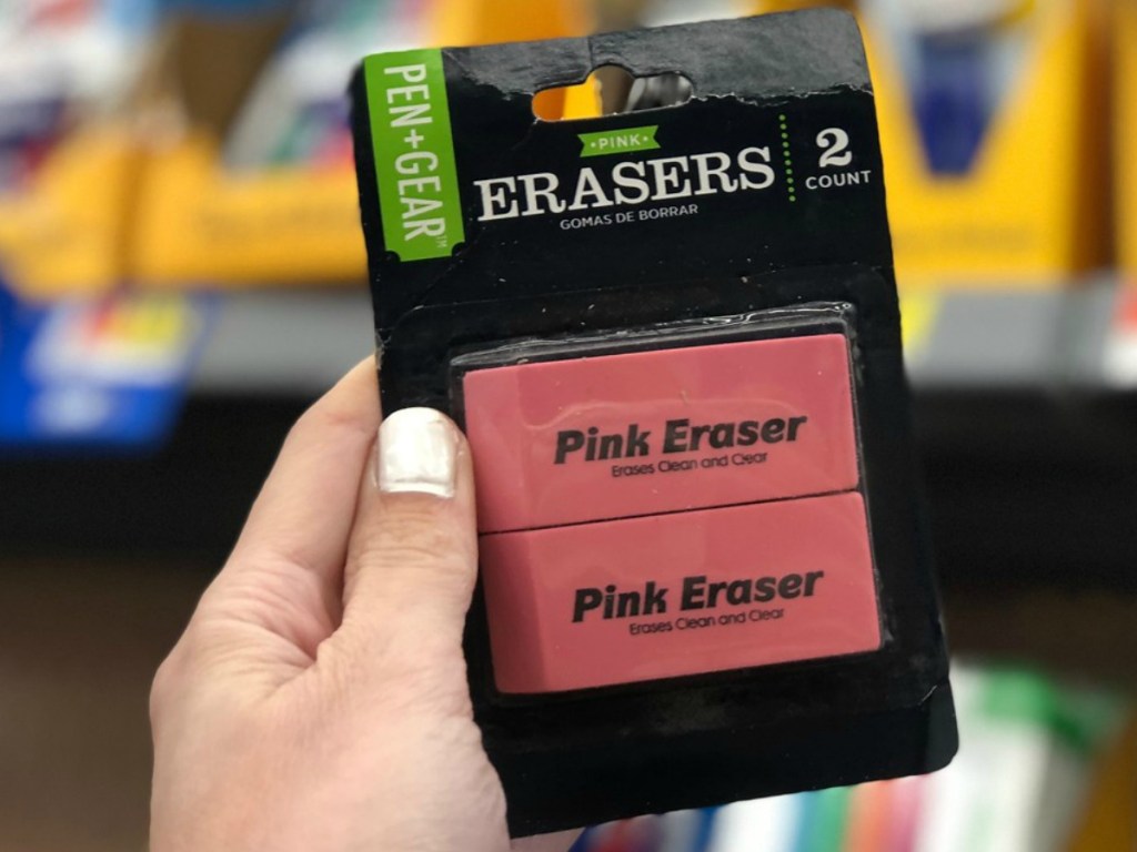 hand holding package of school pink erasers
