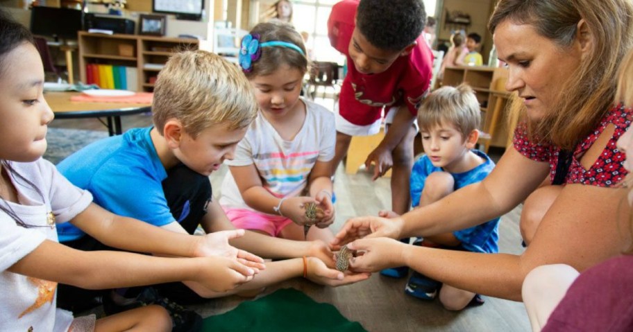 kids holding class pet