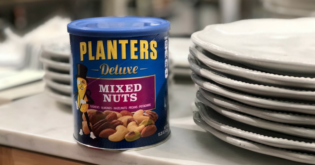 planters nuts canister next to stack of plates