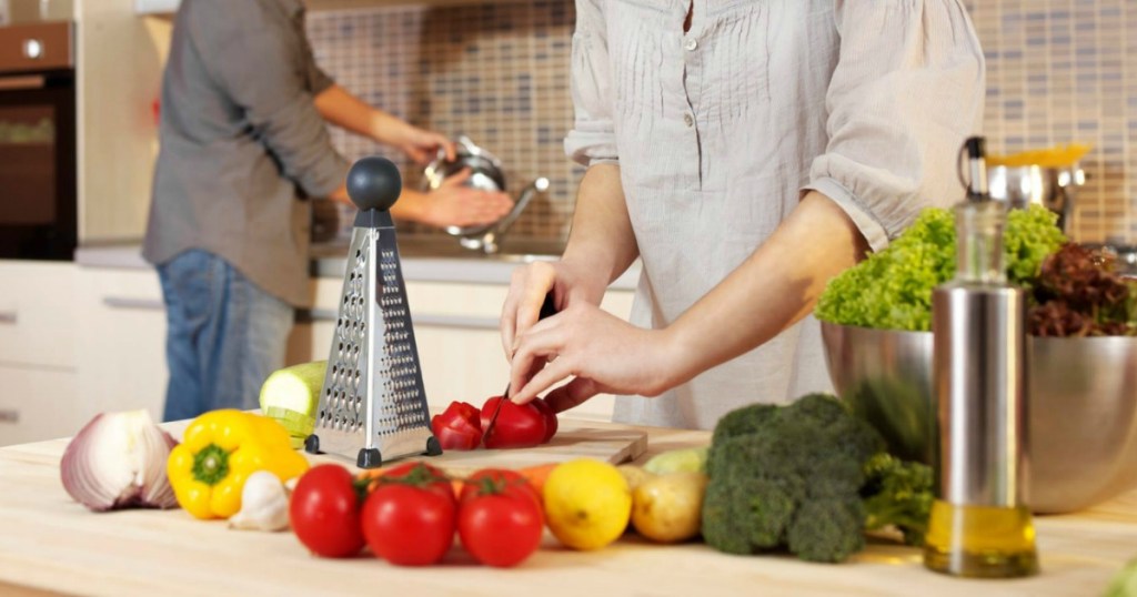 Woman chopping veggies in kitchen