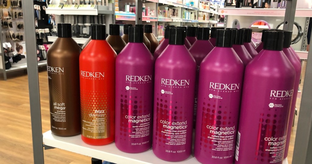 big bottles of Redken shampoo on a store shelf