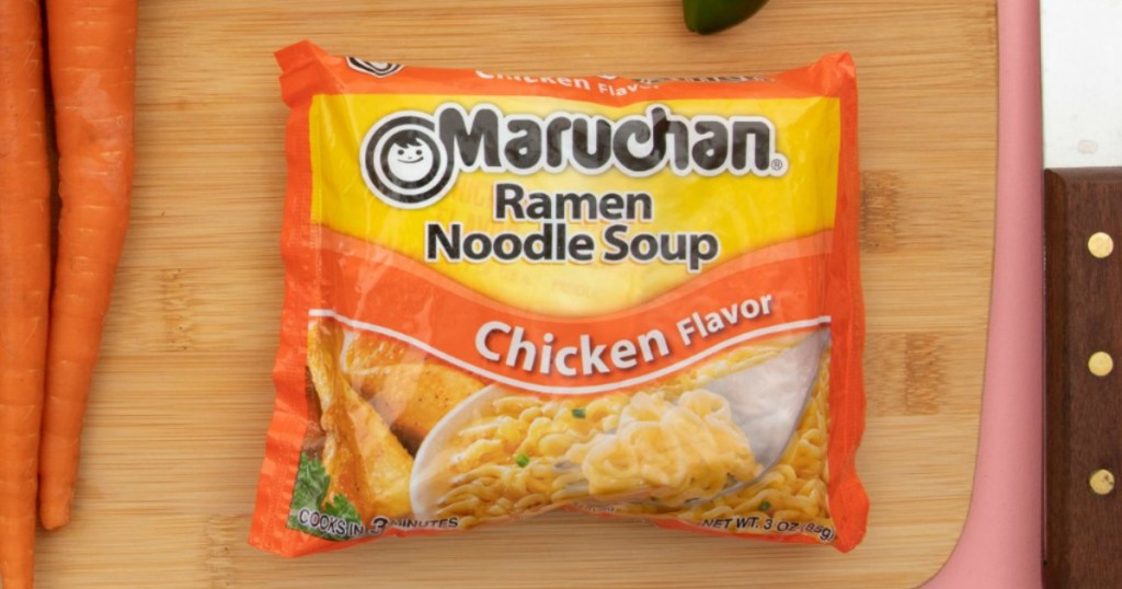 Package of ramen noodle soup chicken flavor on cutting board