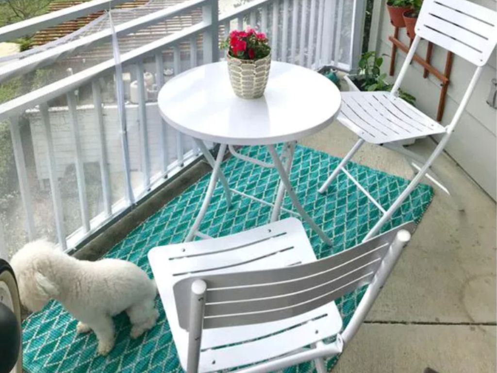 Room Essentials Metal Outdoor Patio Bistro Set in White with teal rug and dog