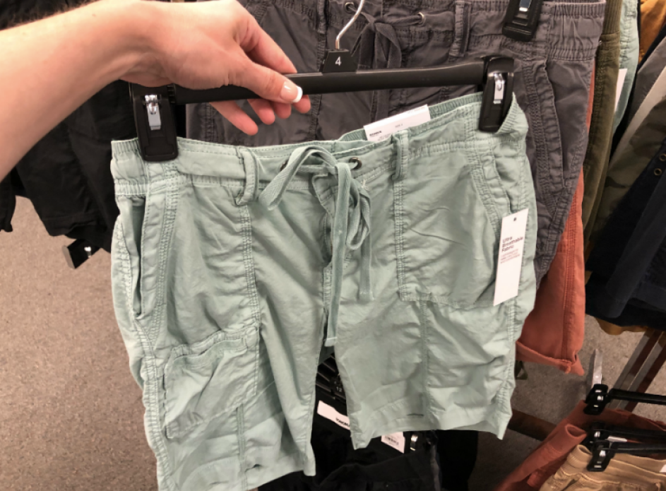 Woman holding green pair of SONOMA Goods for Life Front Pocket Shorts