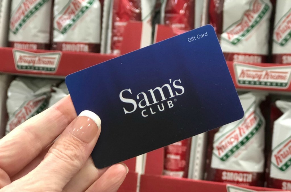 Sam's Club Gift Card in-hand in front of Krispy Kreme coffee store display