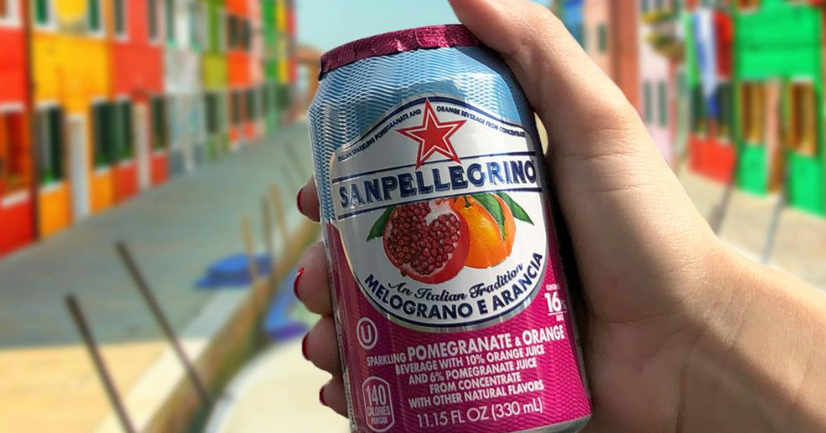 Can of San Pellegrino in hand outside