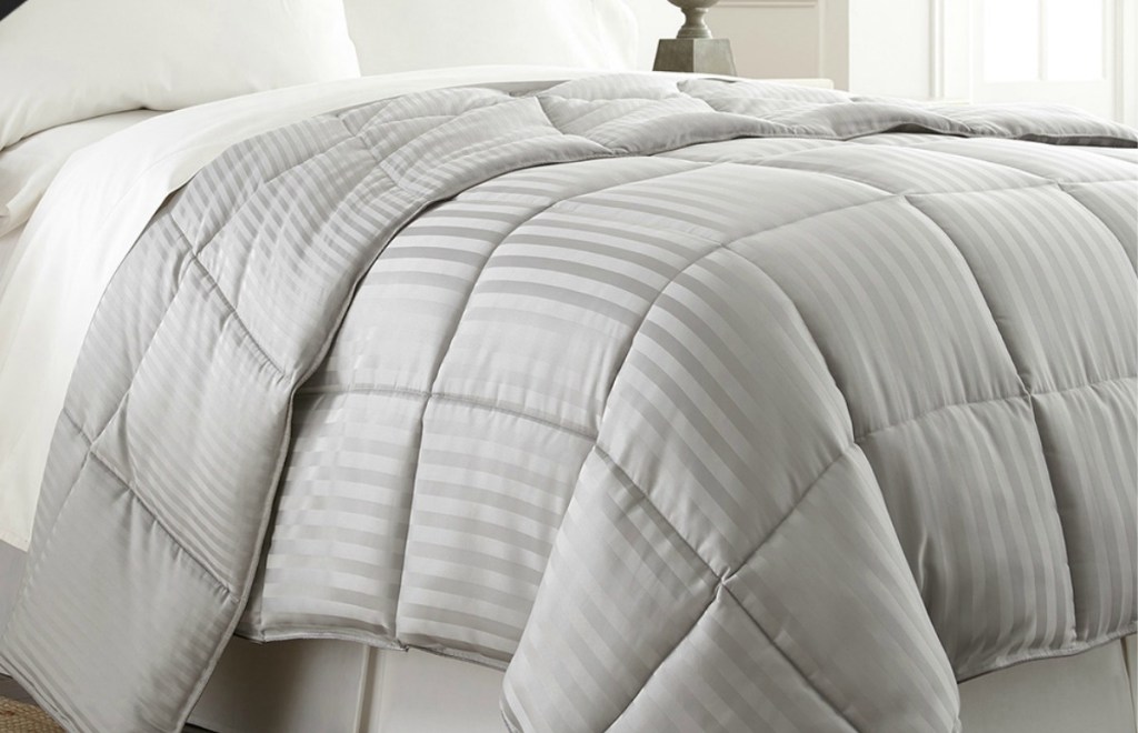 Silver striped down alternative comforter on bed