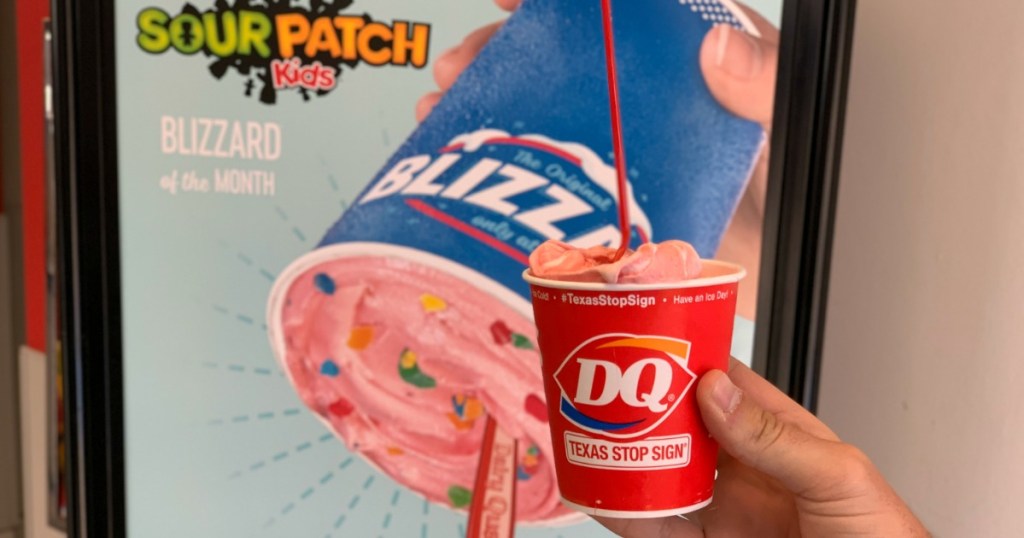 Holding Sour Patch Kids Blizzard in front of sign
