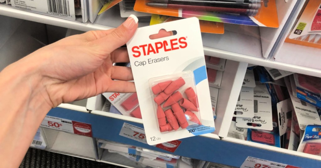 hand holding pack of Staples Cap Erasers
