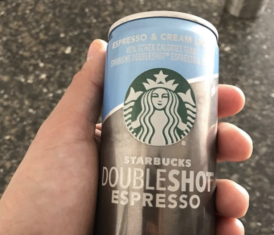 Person holding Starbucks Doubleshot Espresso + Cream Light can