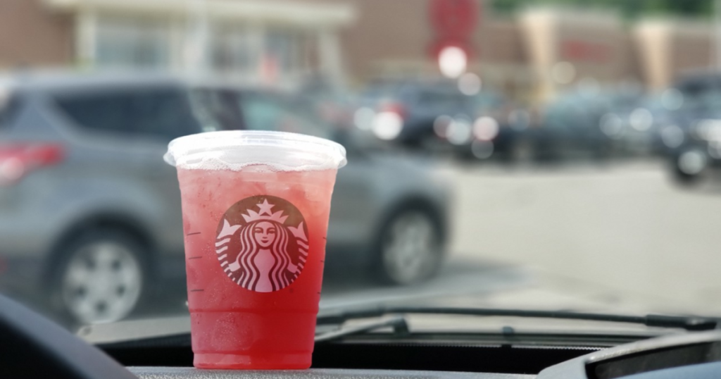 Starbucks on dash of car in Target parking lot