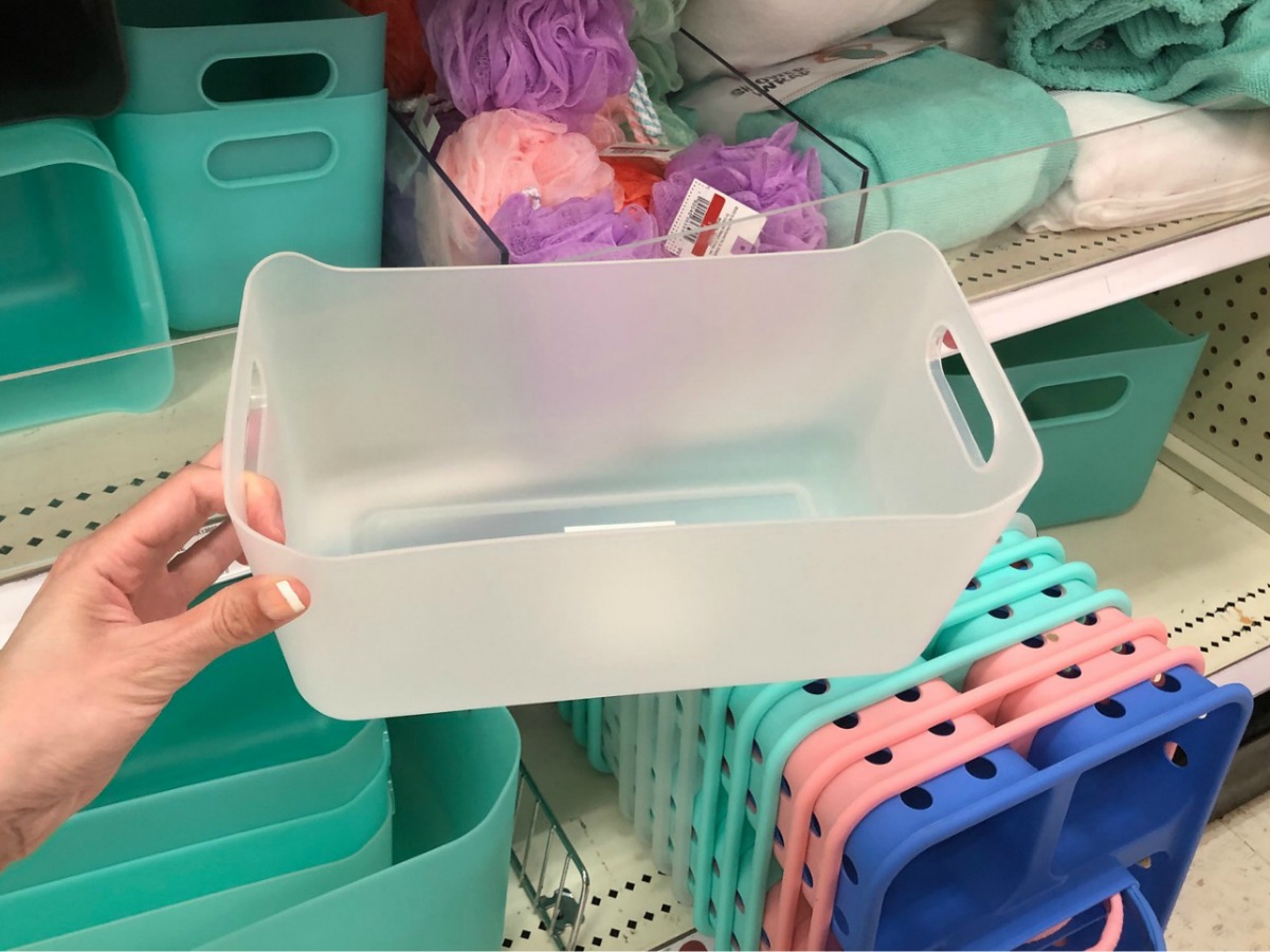hand holding a shower caddy in front of a Target store shelf