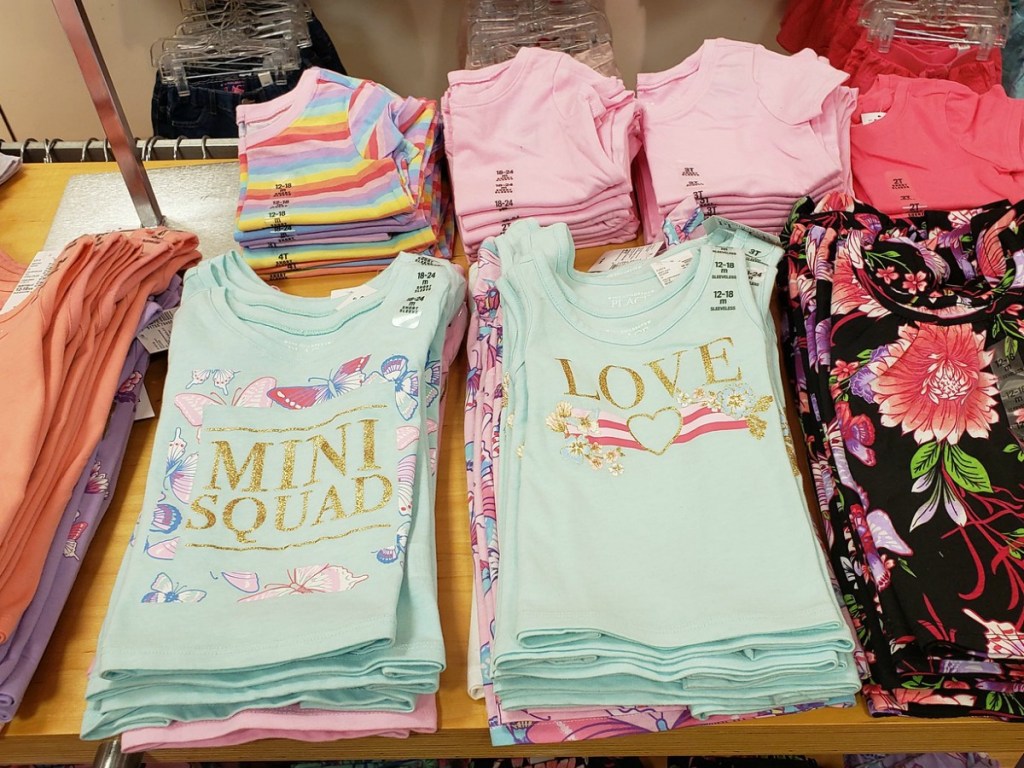 Toddler's graphic tees on display shelf at The Children's Place