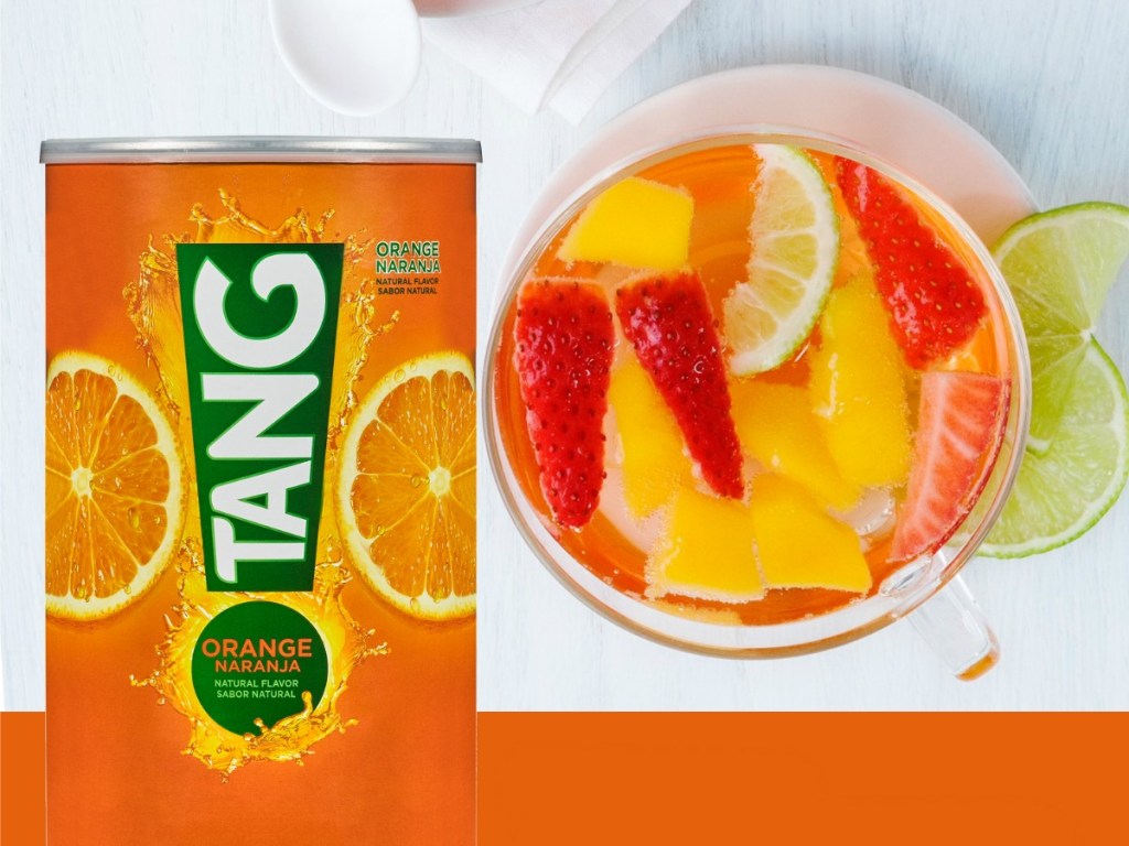 Tang Drink Mix Canister next to fruit punch in cup