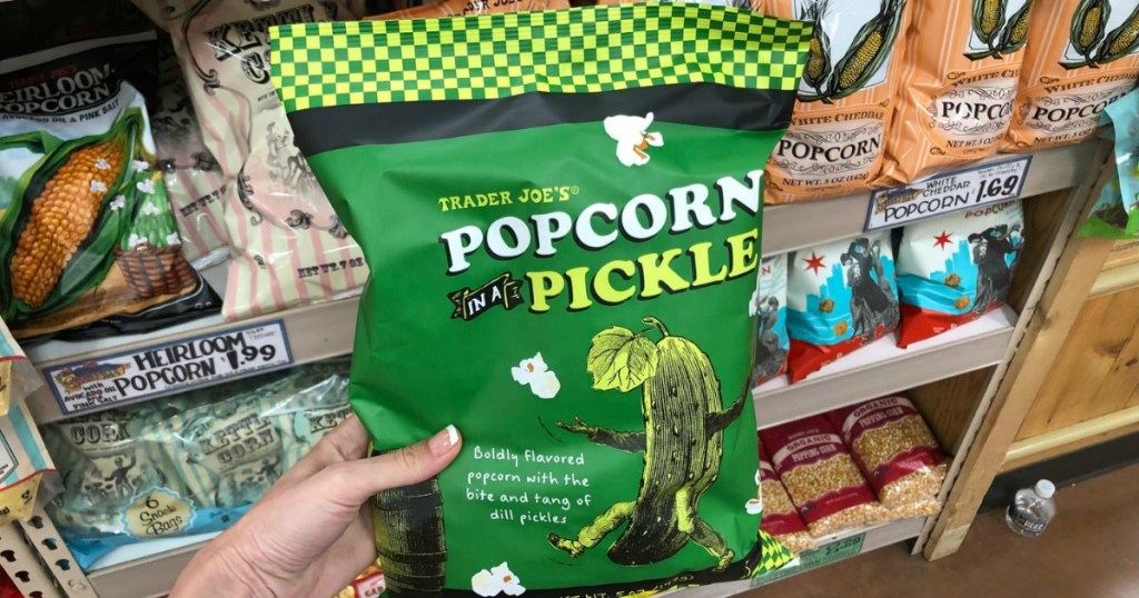 Bag of pickle-flavored popcorn in front of store display of popcorn