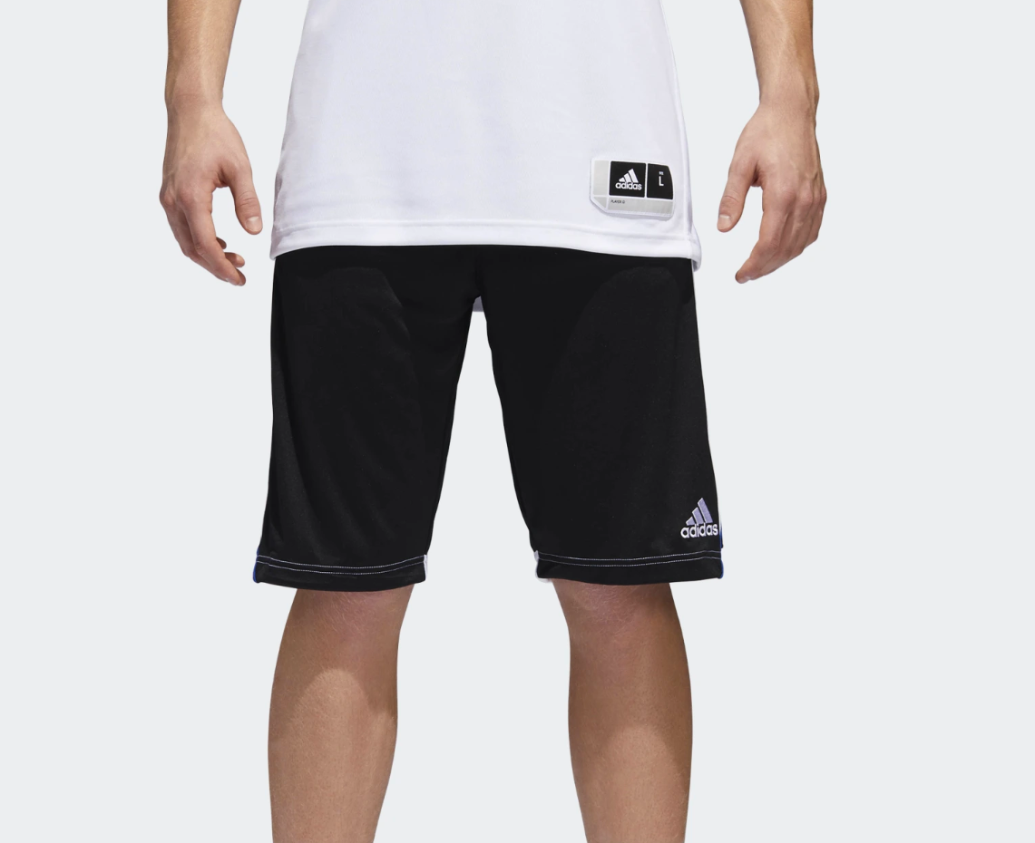 Man wearing black adidas sport shorts and white shirt