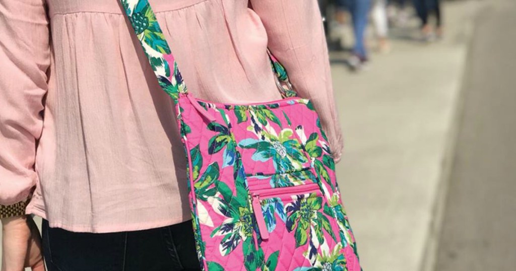 Vera Bradley Crossbody Pink with Green Flowers being carried by worman with pink shirt