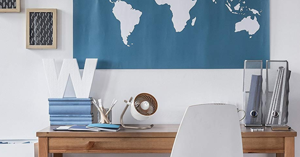 Vornado Pivot Personal Air Circulator Fan on desk with world map on wall