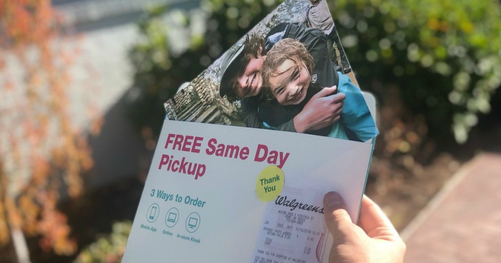 someone holding a Walgreens photo print of kids