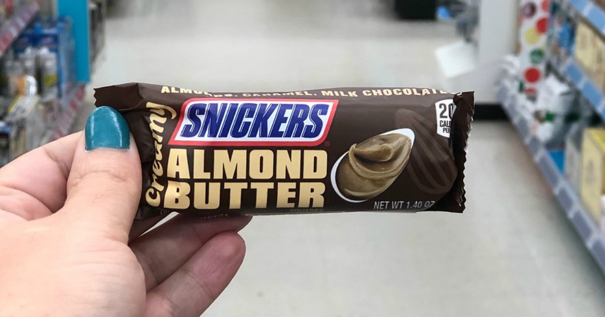 hand holding snickers creamy candy bar at walgreens