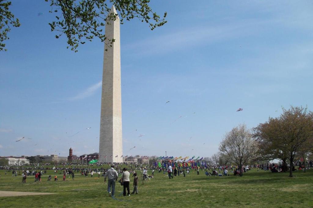 Washington Monument with people flying kites
