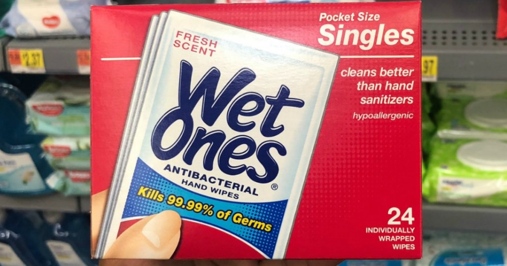 Hand holding wet ones single packs box