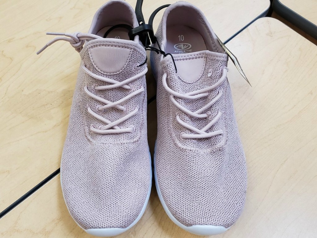 pair of light pink shoes on table