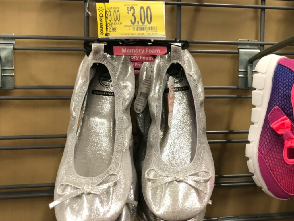 silver shoes hanging in store by price tag