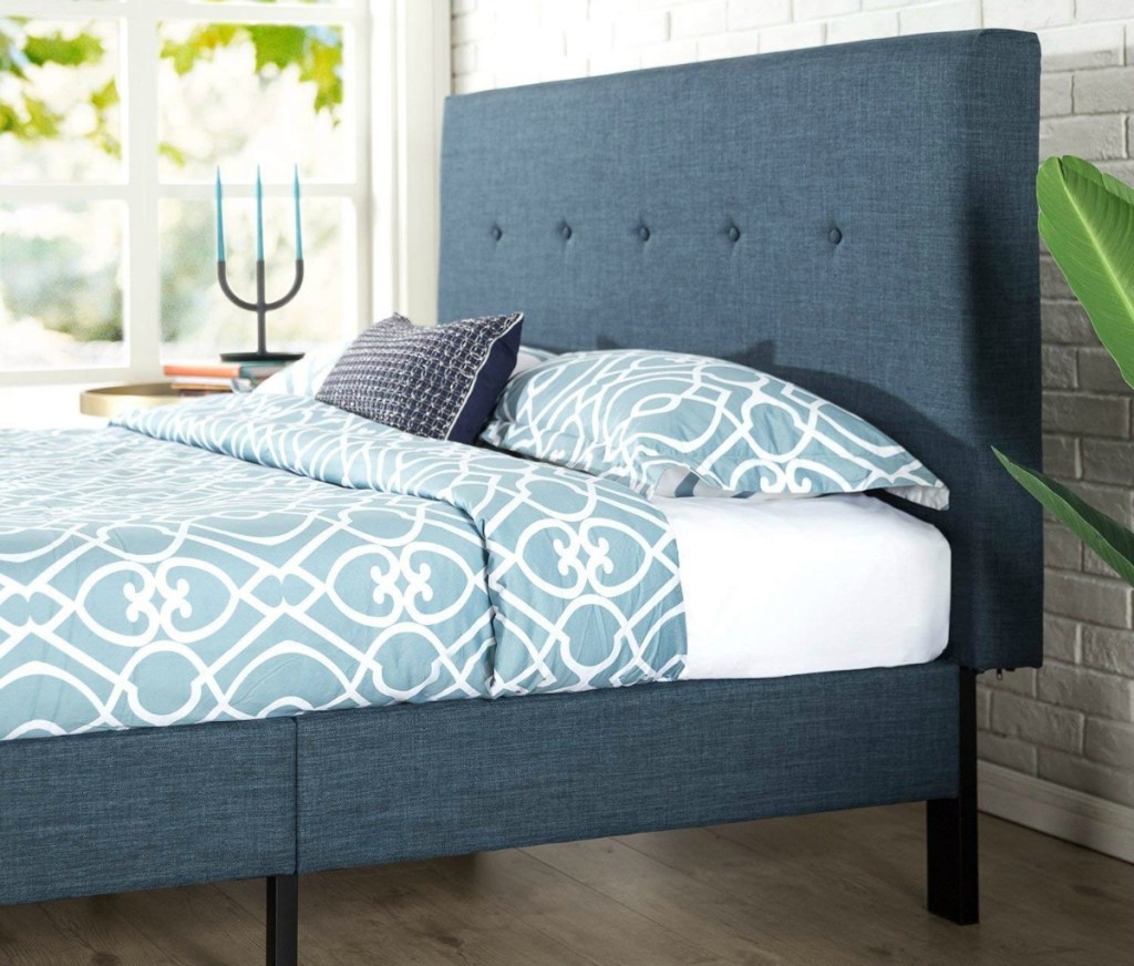 closeup of a blue platform bed with headboard