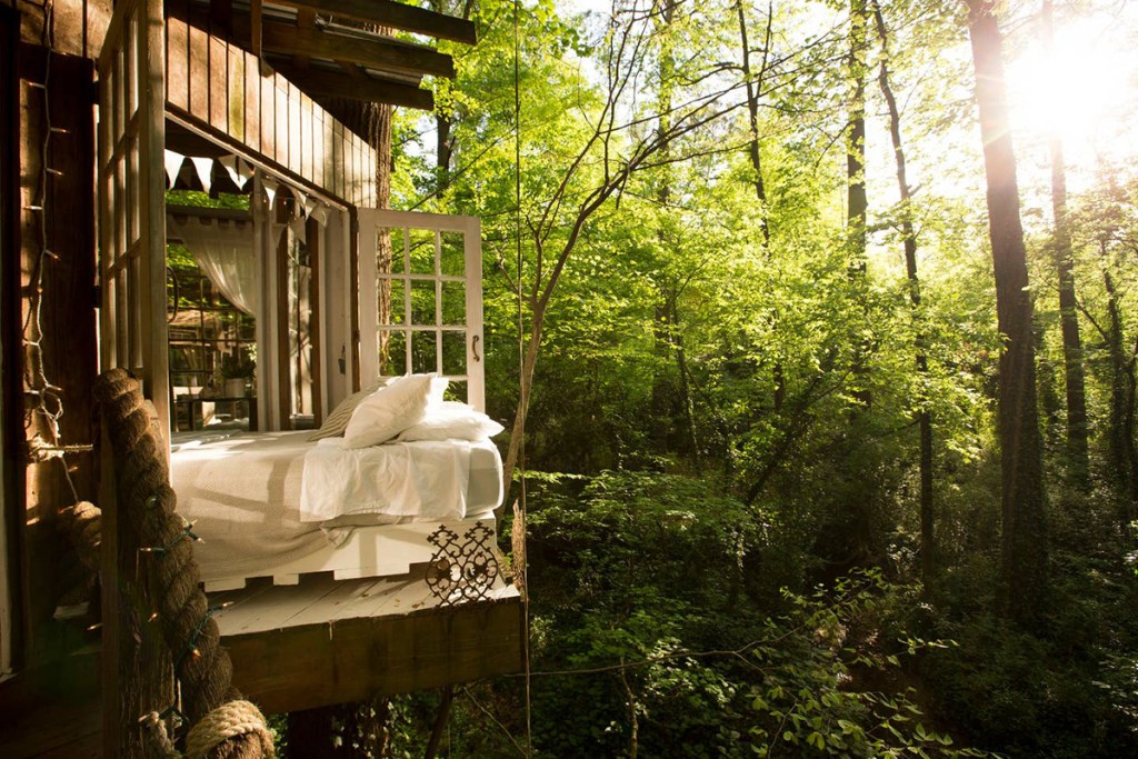 bed on balcony in atlanta treehouse airbnb