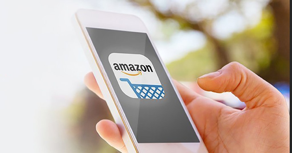holding smartphone with Amazon app screen