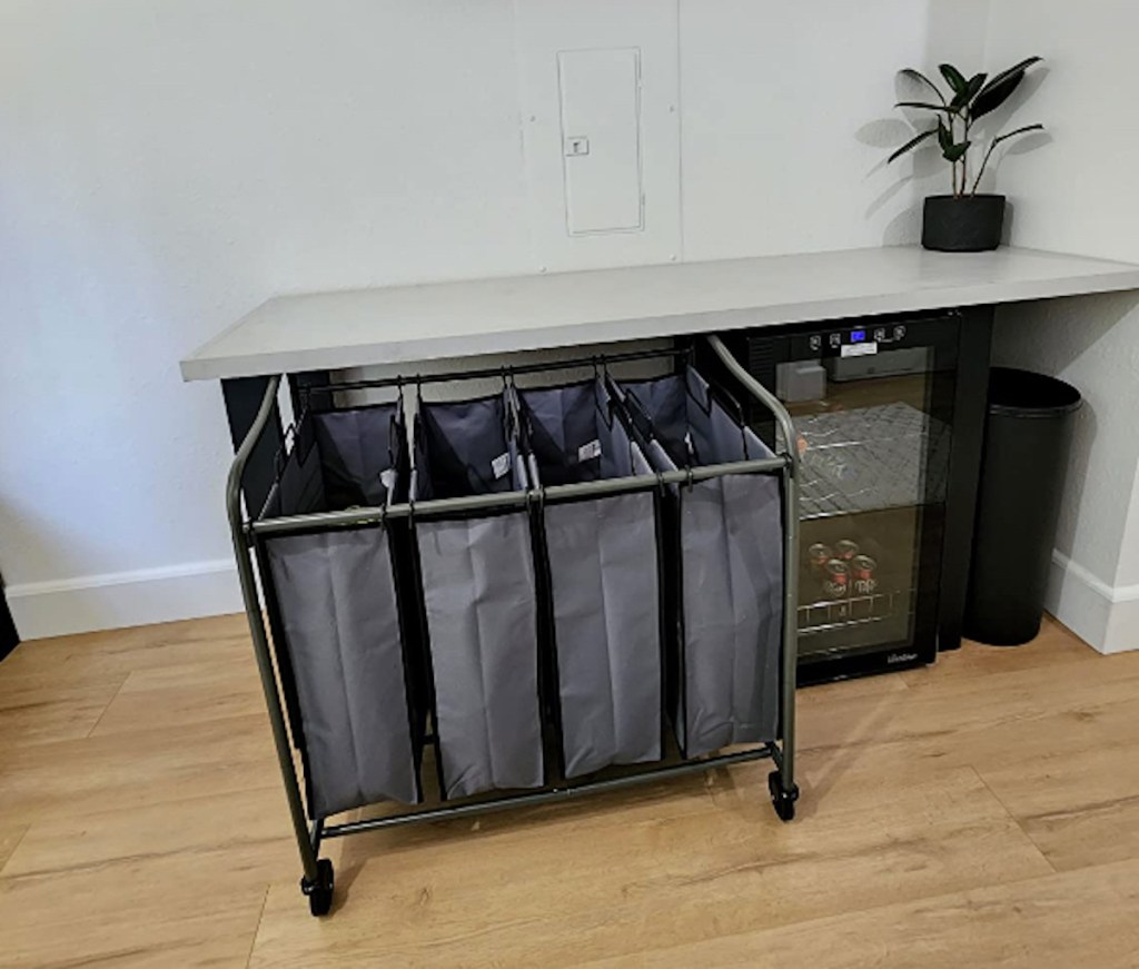 gray rolling laundry cart under countertop