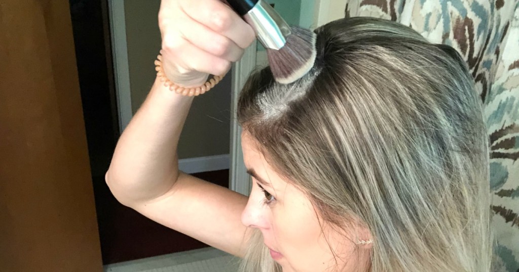 putting DIY dry shampoo in hair with makeup brush 