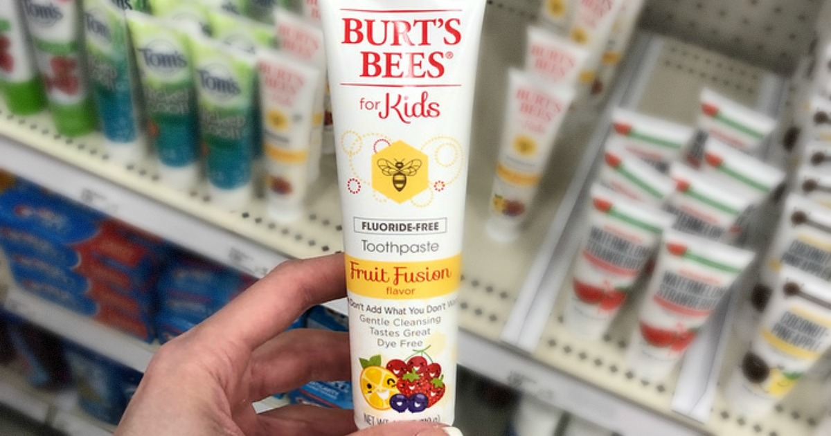 hand holding burts bees kids toothpaste in store