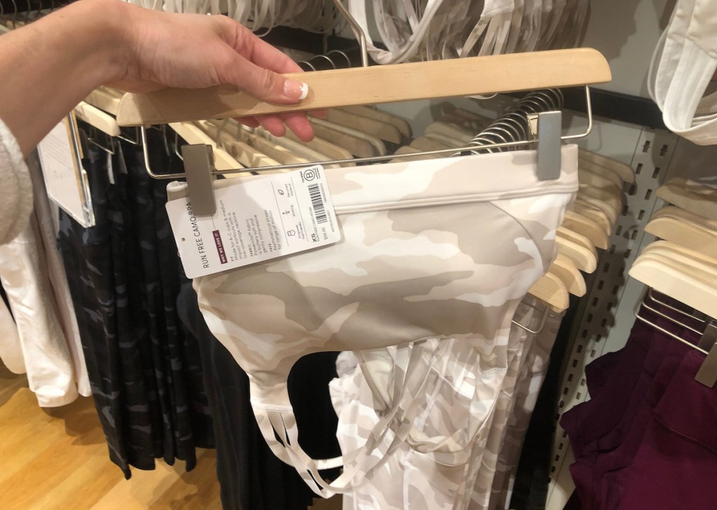 hand holding camo bra on hanger