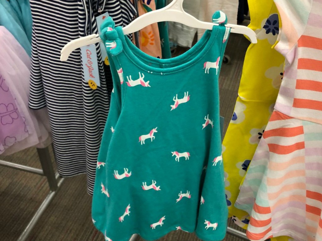 green little girls dress on hanger in store